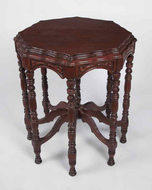 Appraisal: CARVED OCTAGON OCCASIONAL TABLE Shaped top with carved skirt Turned