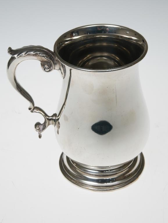 Appraisal: SILVER BALUSTER TANKARD LONDON the s-scroll handle with leaf-cast thumb