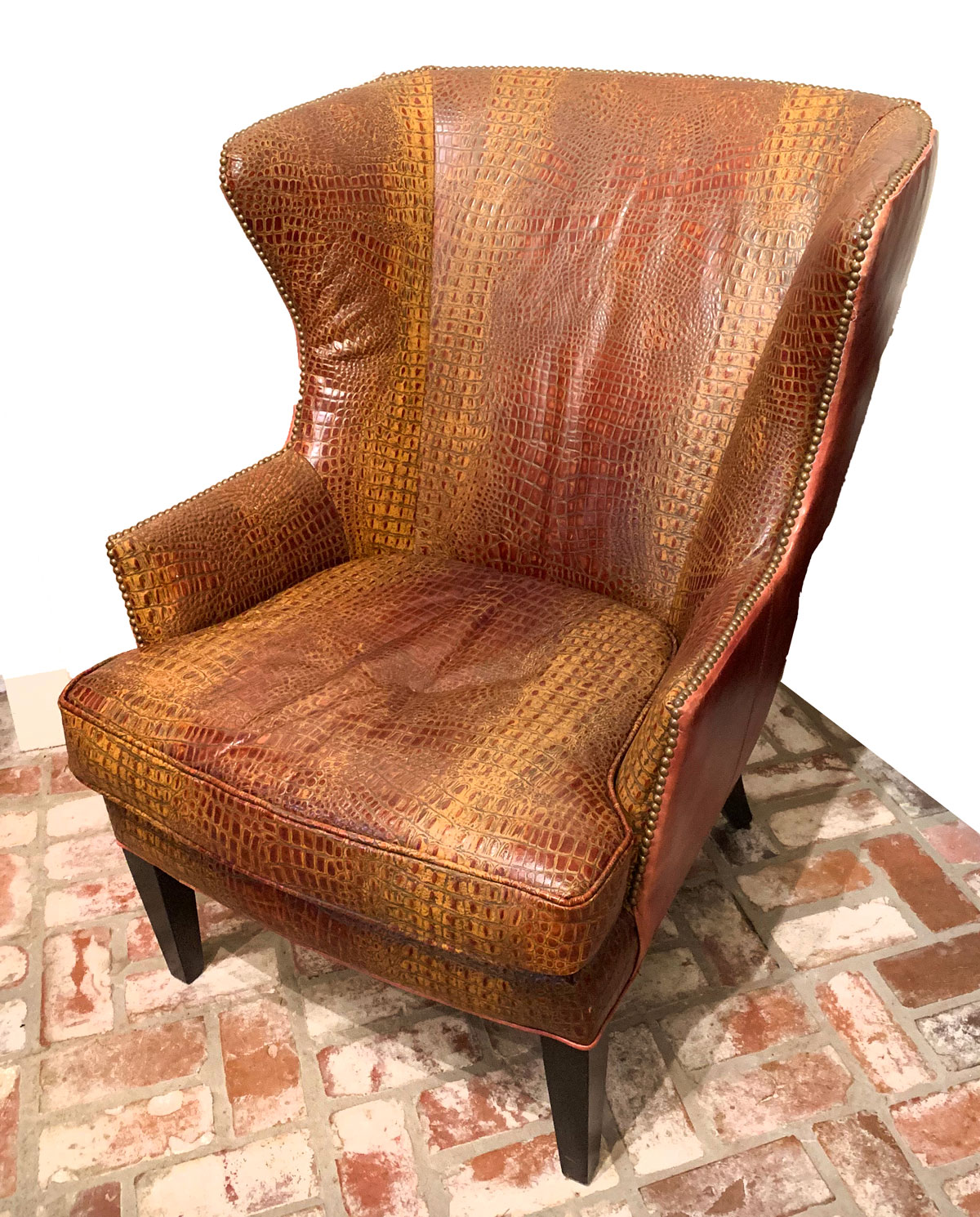 Appraisal: ALLIGATOR WING BACK CHAIR Alligator winged back chair of tooled