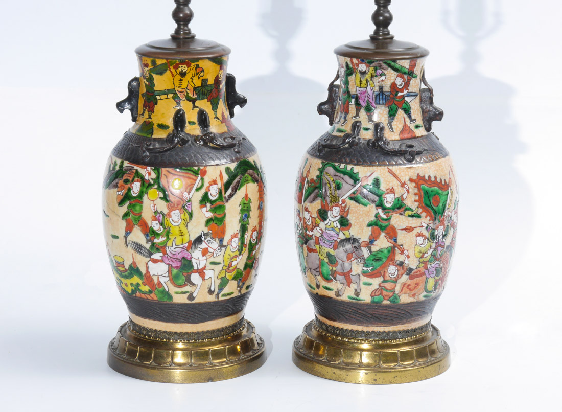 Appraisal: PAIR ORIENTAL POTTERY LAMPS Bodies with polychrome incised battle motifs