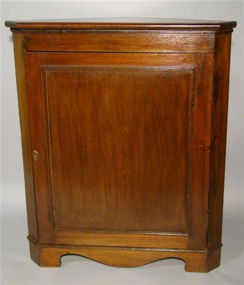 Appraisal: GEORGE III MAHOGANY CORNER CABINET the molded top above a