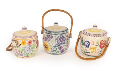 Appraisal: Poole Pottery three floral biscuit barrels with raffia handles all