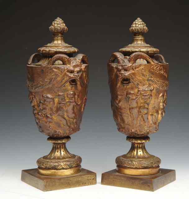 Appraisal: A PAIR OF BRONZE FINIALS AFTER CLODION decorated with masks