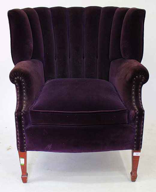 Appraisal: AN EDWARDIAN MAHOGANY FRAMED WING ARMCHAIR with purple velour upholstery