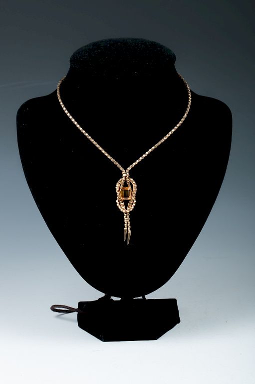 Appraisal: CITRINE AND GOLD NECKLACE Citrine emerald on an interlaced knot