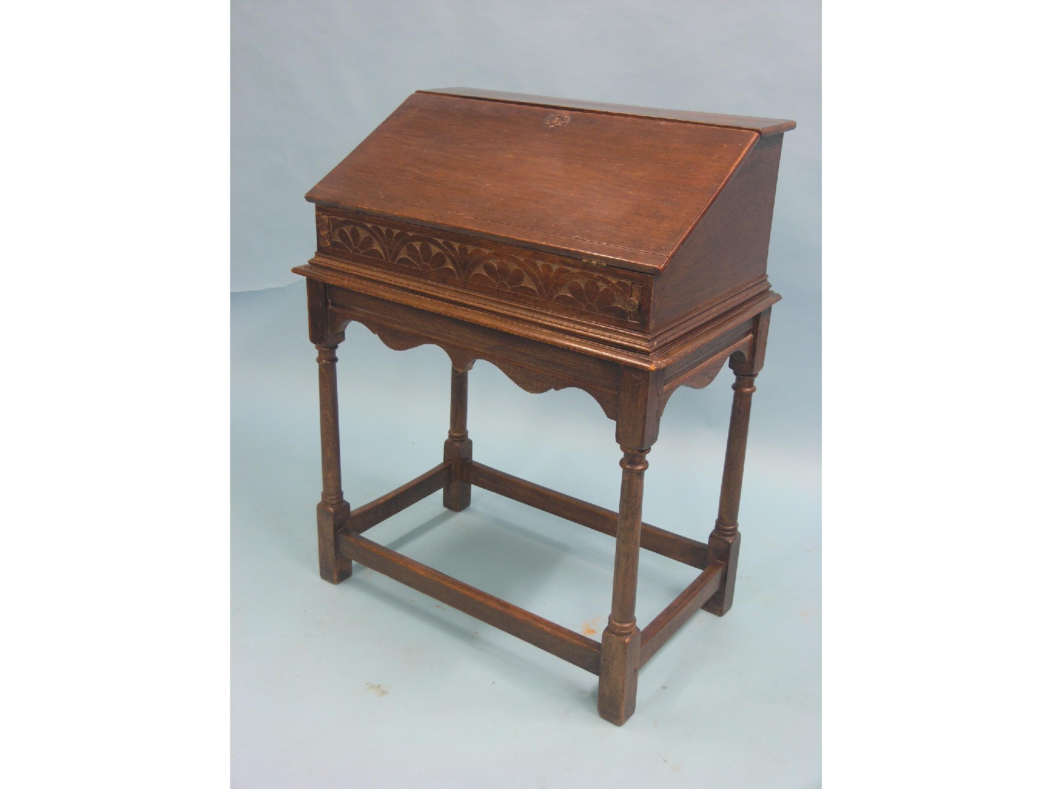 Appraisal: A William and Mary-style oak bureau on stand fall-front enclosing