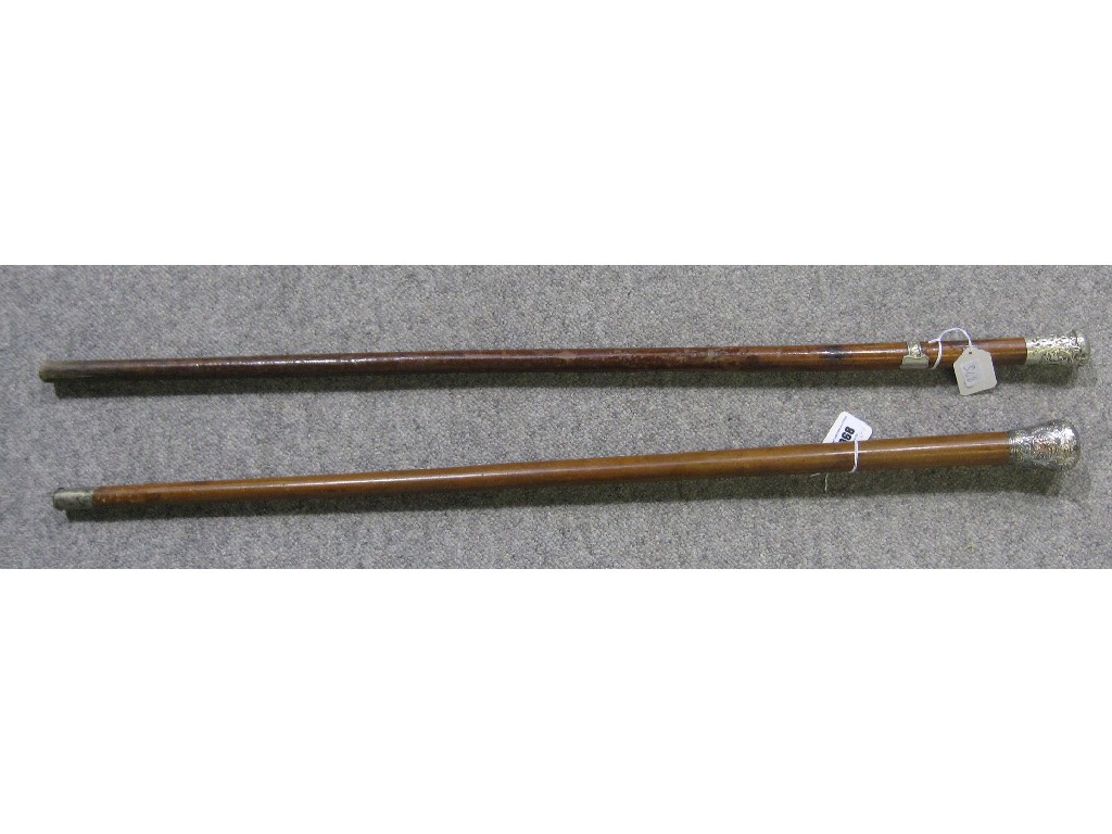 Appraisal: Lot comprising two white metal topped walking sticks