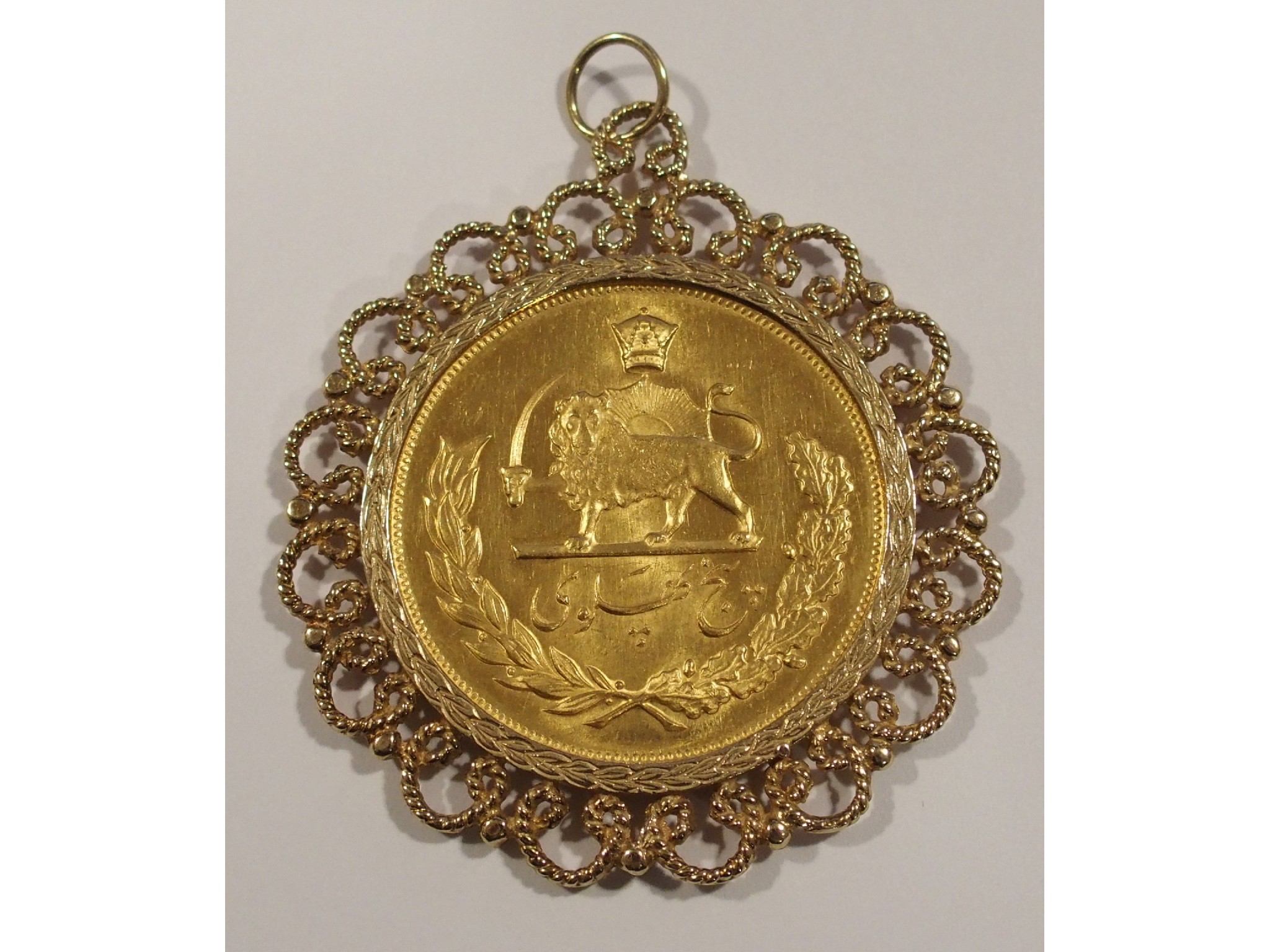 Appraisal: Iran gold five Pahlavi gold mounted in ct scrollwork frame