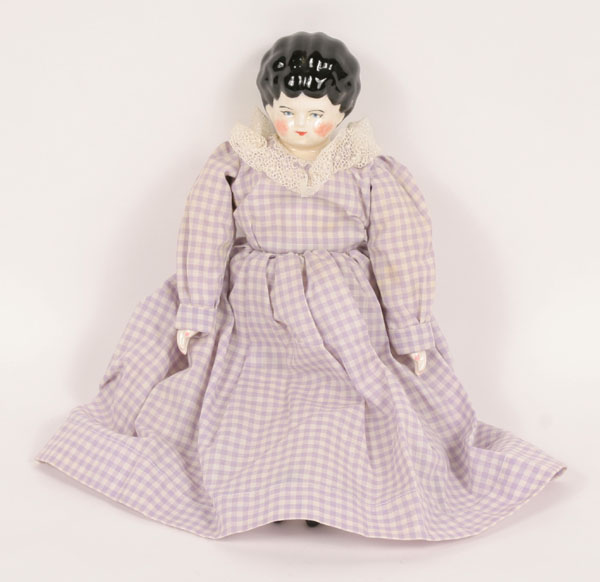 Appraisal: Nineteenth century molded china head doll in lavender gingham dress