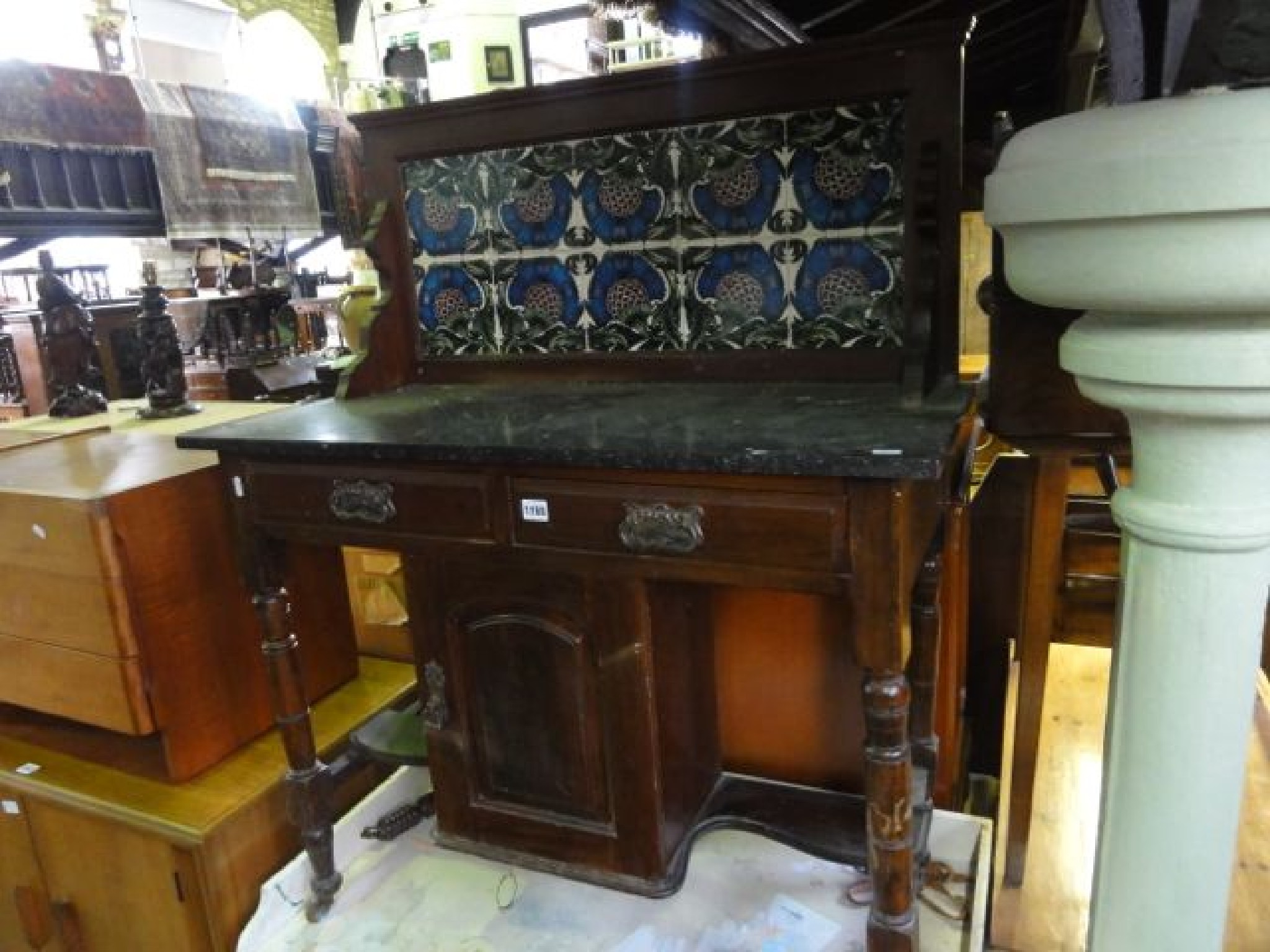 Appraisal: An Edwardian stained walnut washstand with marble top and splashback