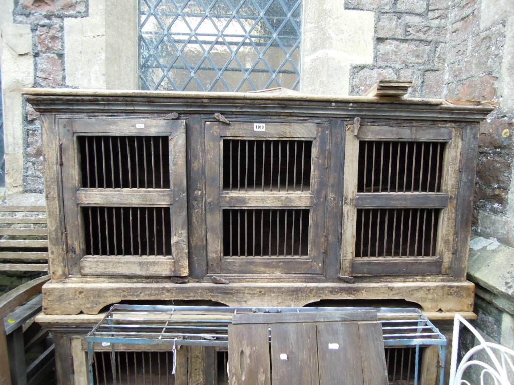 Appraisal: A pair of low hardwood side food cupboards each enclosed