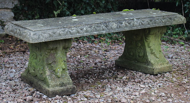 Appraisal: AN OLD RECONSTITUTED STONE RECTANGULAR TOPPED GARDEN BENCH with scroll