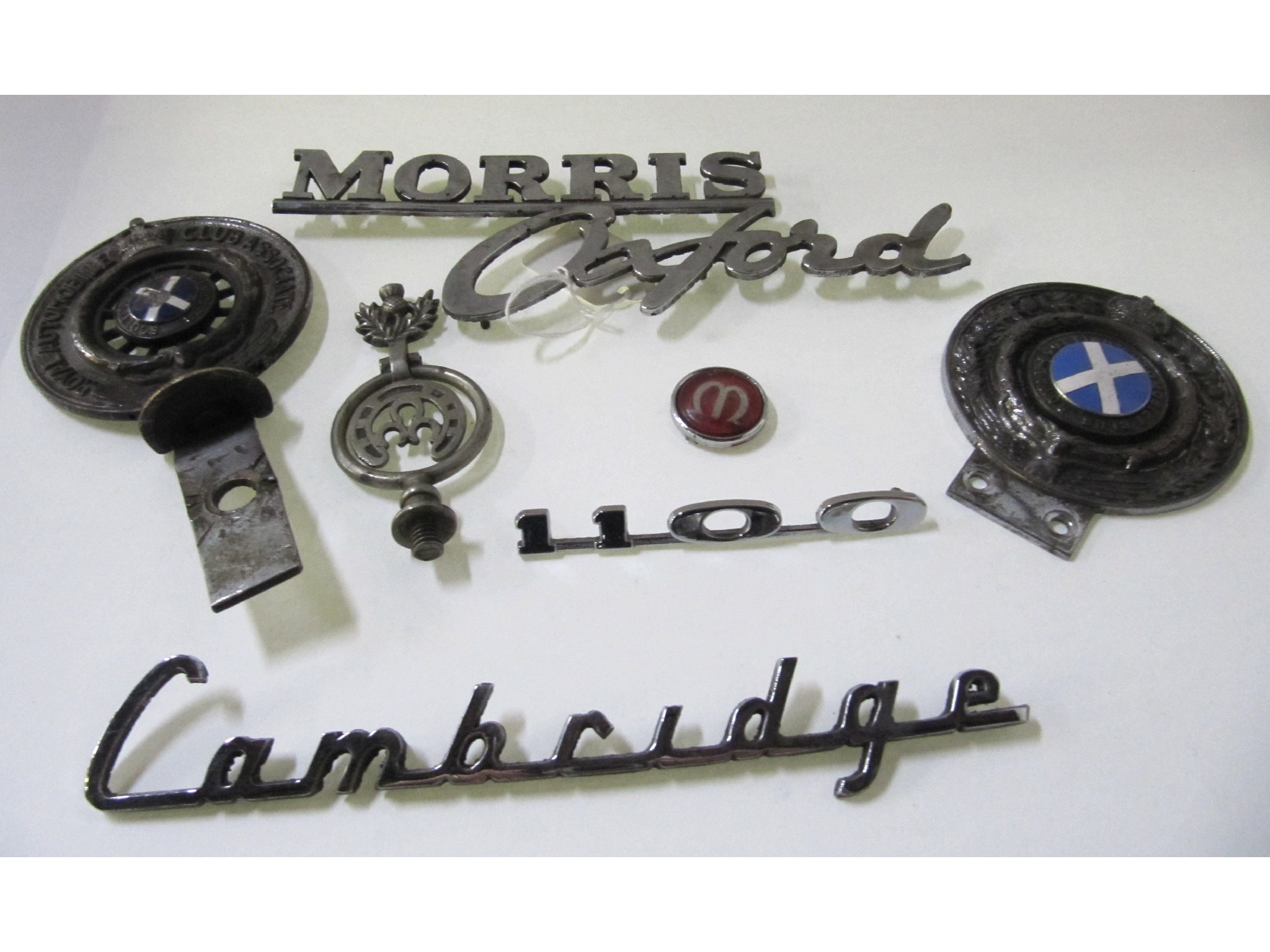 Appraisal: A lot comprising two car badges and insignia - Morris