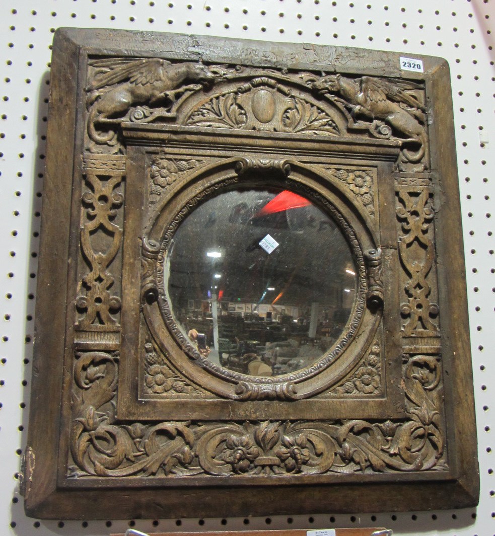 Appraisal: A th century faux oak fibreglass wall mirror