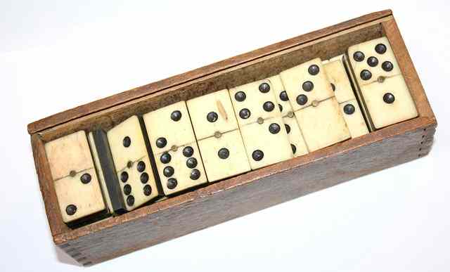 Appraisal: A CASED SET OF BONE AND EBONY DOMINOES IN A