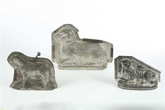 Appraisal: THREE CHOCOLATE MOLDS Tin with metal straps Two seated sheep