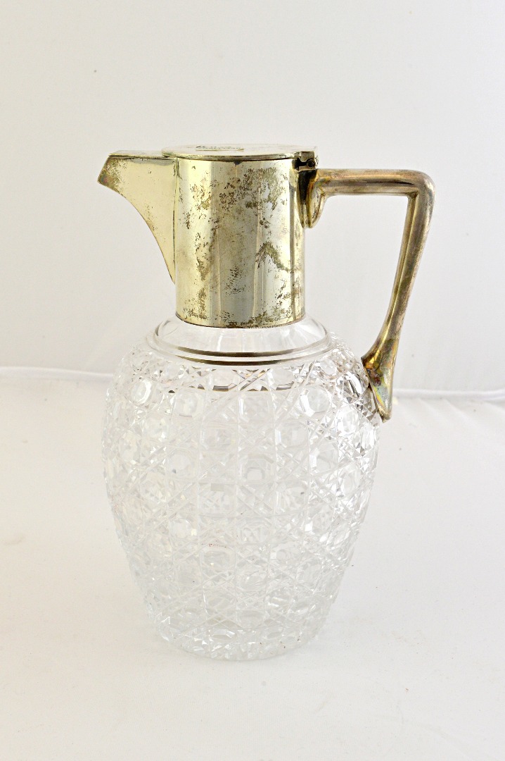 Appraisal: A Victorian silver mounted faceted glass claret jug having an