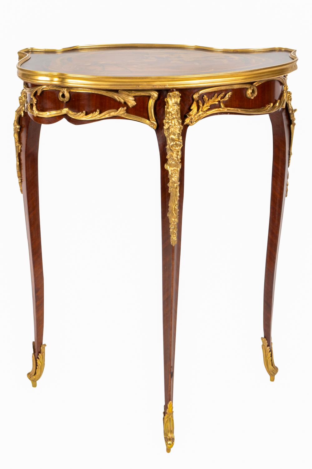 Appraisal: LOUIS XV STYLE GILT BRONZE-MOUNTED TABLEmodern the cartouche-shaped top marquetry-inlaid