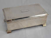 Appraisal: A cedar lined silver cigarette box on four stub feet