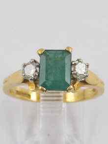 Appraisal: A hallmarked ct gold emerald and diamond ring the emerald