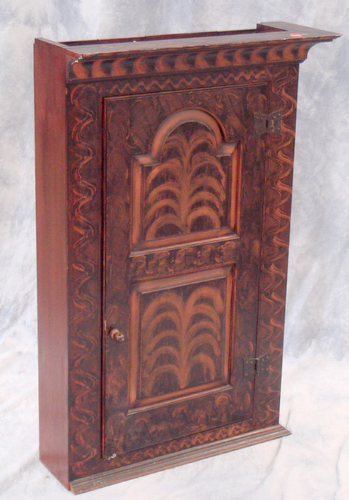 Appraisal: Replica benchmade hanging cupboard with raised panel door grained combed