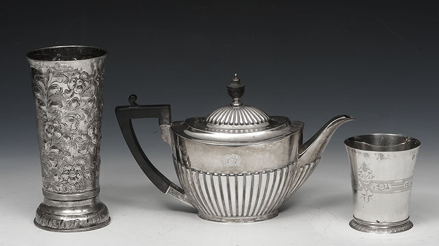 Appraisal: A SILVER OVAL HALF REEDED TEAPOT a silver commemorative beaker