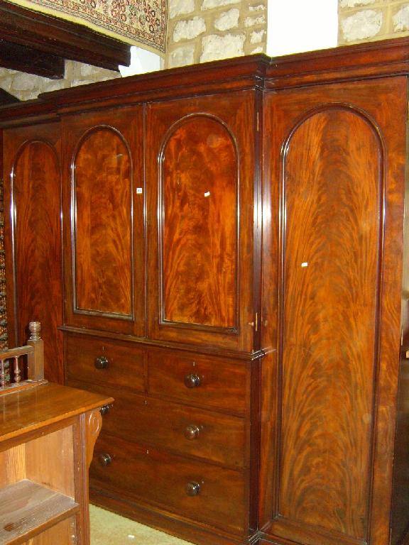 Appraisal: A Victorian mahogany breakfront wardrobe the centre section enclosed by