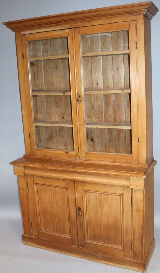 Appraisal: A stripped and lightly polished pine bookcase the upper section