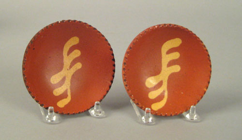 Appraisal: Pair of miniature redware pie plates ca with yellow slip