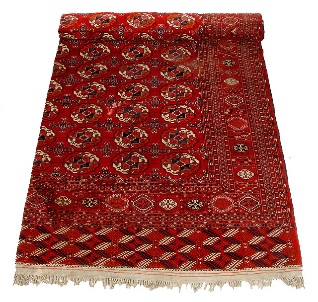 Appraisal: A TEKKE TURKMEN RED GROUND SMALL CARPET with central geometric