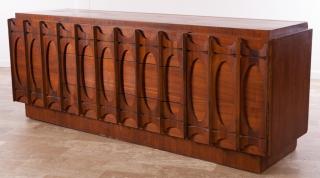 Appraisal: Brasilia-style long dresser having three central drawers flanked by doors