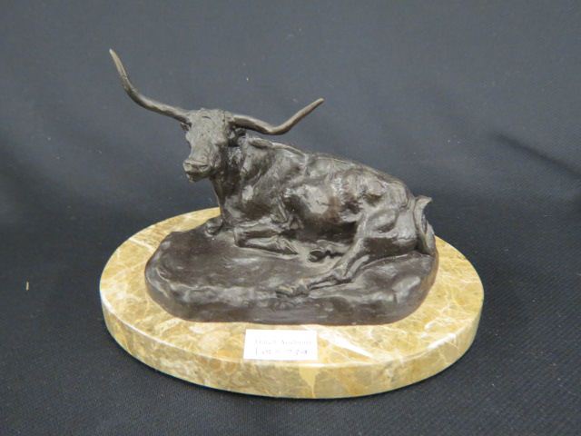 Appraisal: Bronze Statue of a Seated Bull longhorn oval marble base