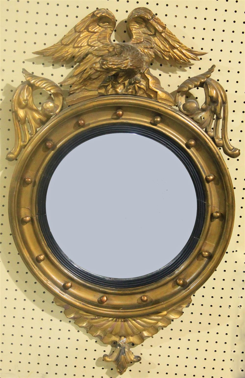 Appraisal: REGENCY STYLE PARCEL GILT BULLSEYE MIRROR WITH EAGLE having a