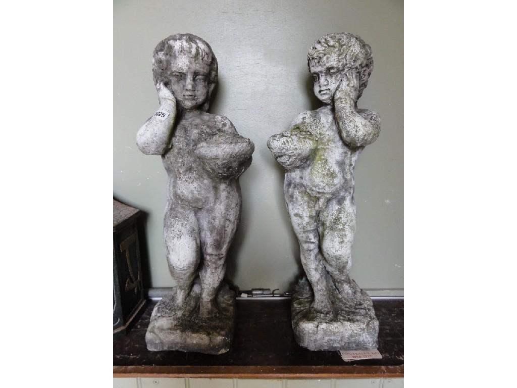 Appraisal: A pair of composition stone garden figures of cherubs in