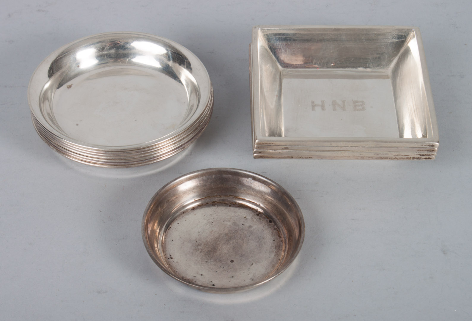 Appraisal: Twelve American sterling silver ashtrays including Wm B Kerr square