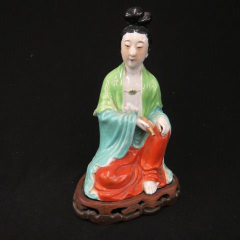 Appraisal: Chinese Porcelain Figurine of Guan Yin seated signed carved wooden