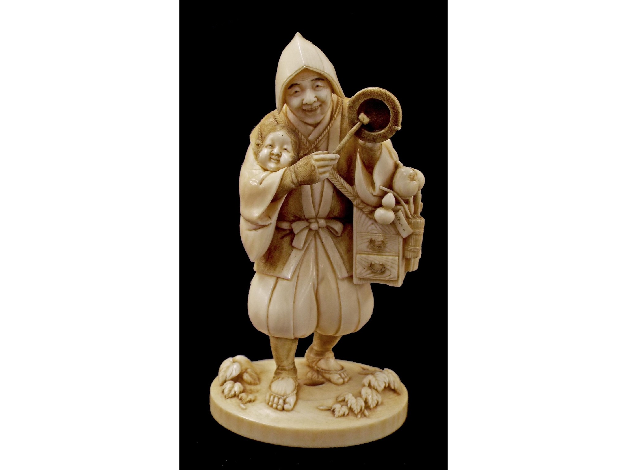 Appraisal: Japanese ivory okimono carved and modelled as a tradesman holding