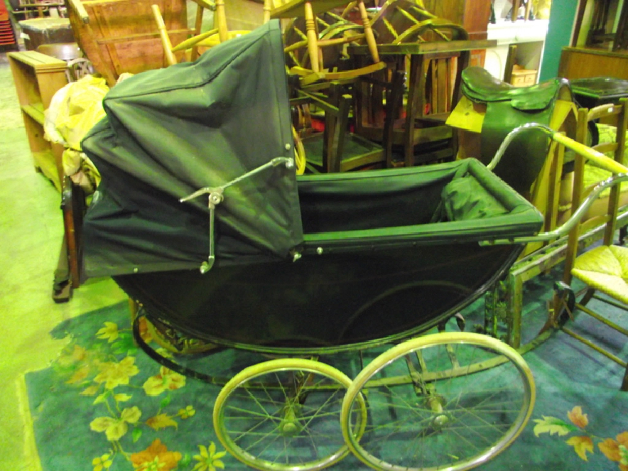 Appraisal: A vintage coach built pram with sprung frame painted finish