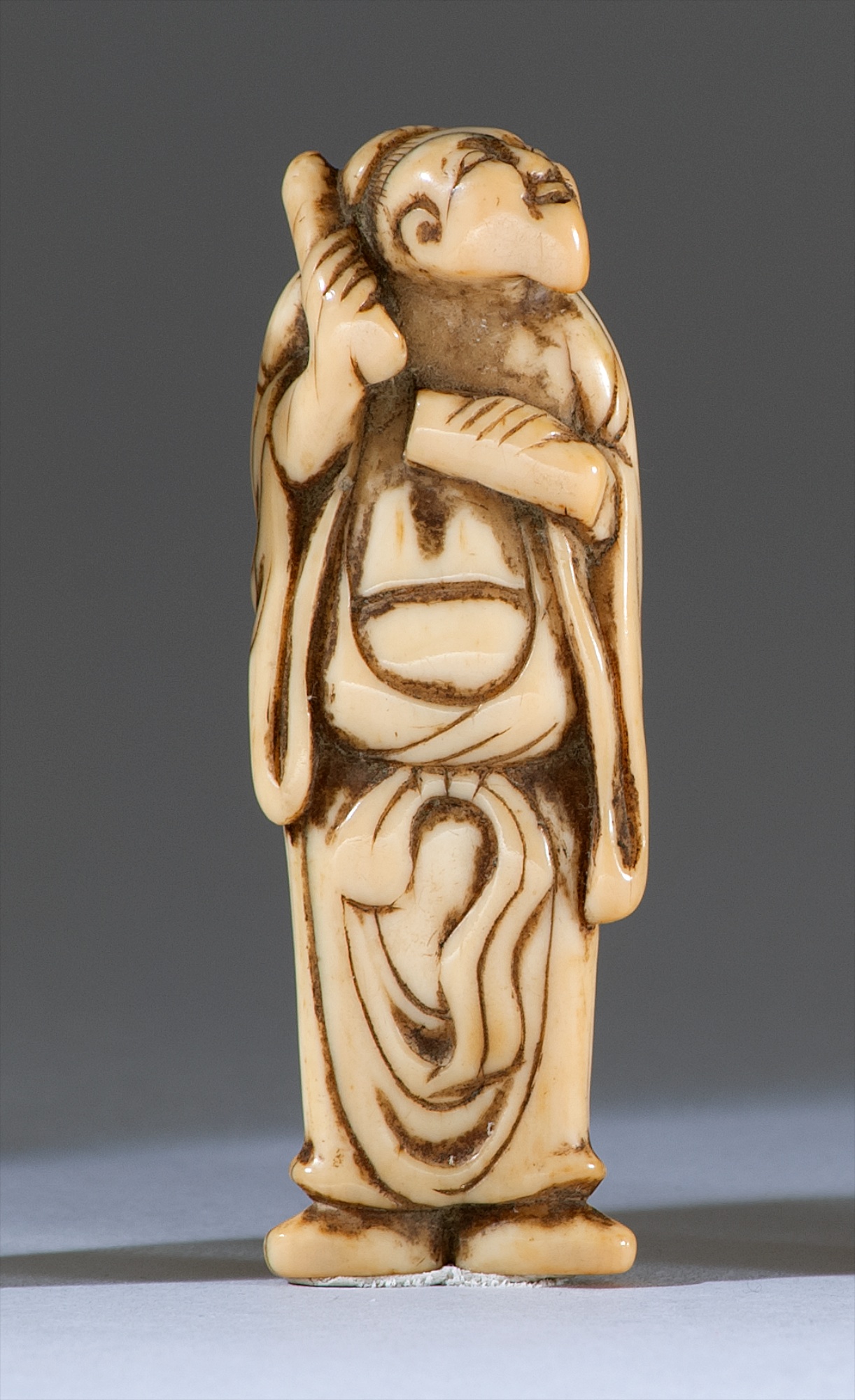 Appraisal: IVORY NETSUKE th CenturyIn the form of a standing sennin