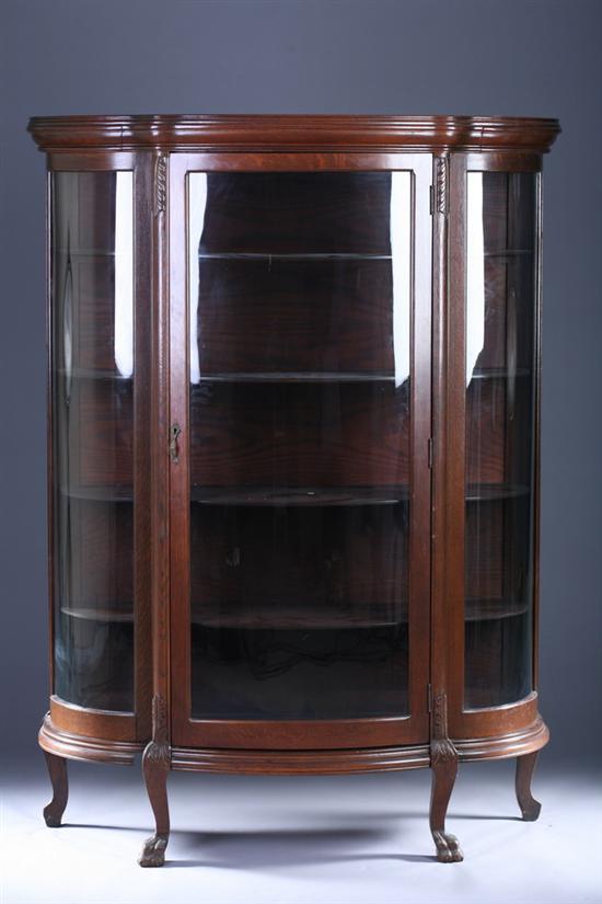 Appraisal: OAK TRIPLE-LOBED CHINA CABINET Early th Century Molded crown over