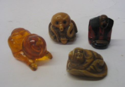 Appraisal: FOUR JAPANESE AND CHINESE NETSUKE a wooden carved and lacquered