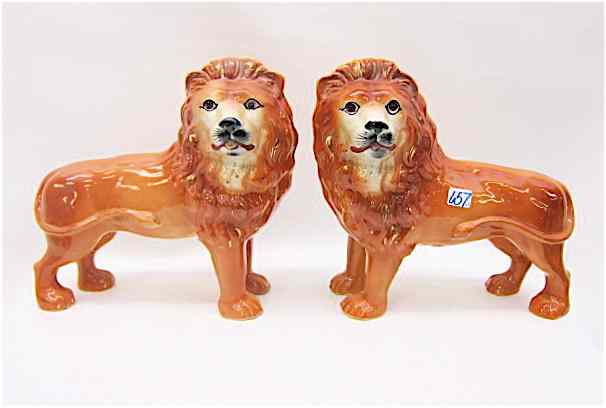 Appraisal: PAIR ENGLISH PORCELAIN STAFFORDSHIRE LIONS in opposing positions rust color