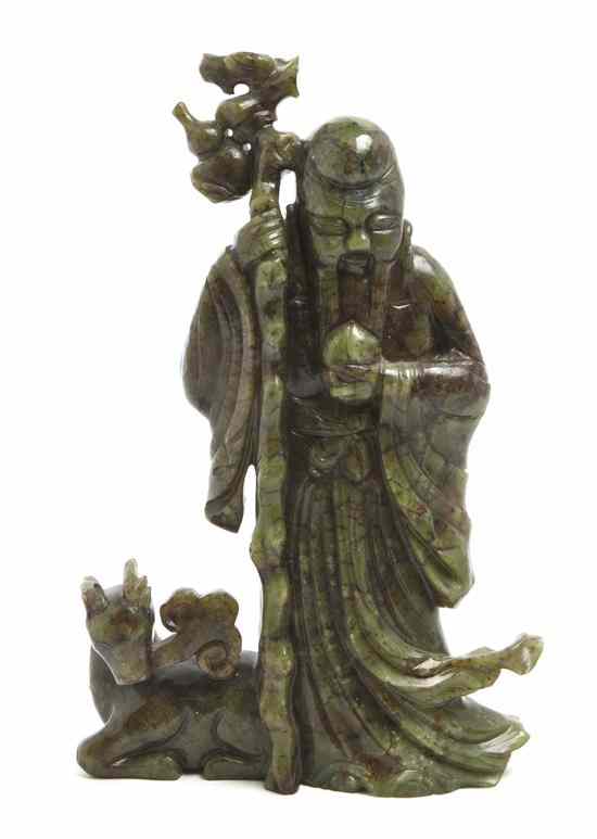 Appraisal: A Spinach Jade Carving of Shoulao depicted standing with flowing