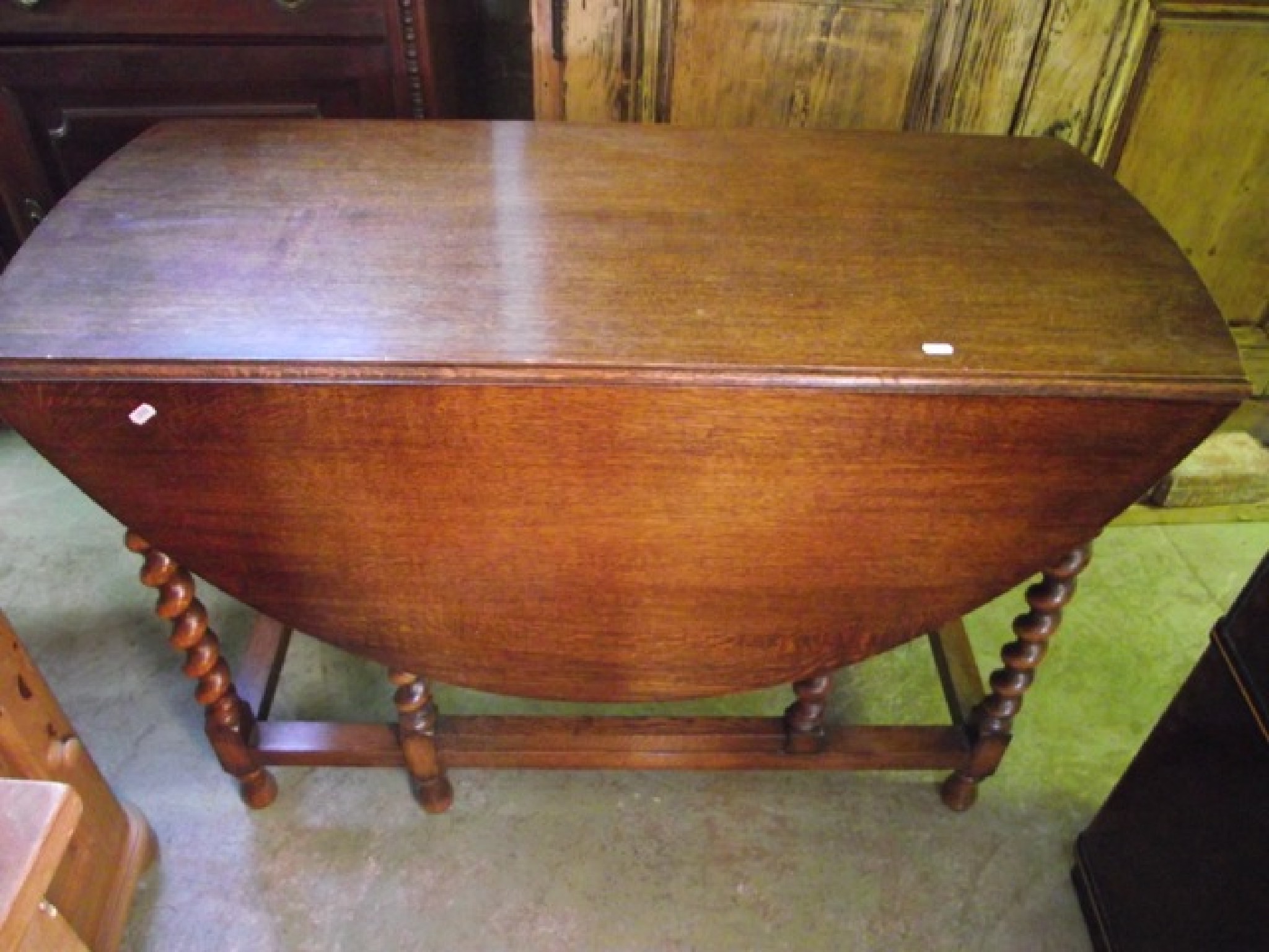 Appraisal: An early th century oak oval drop leaf gateleg dining