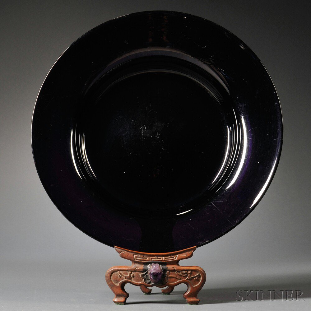 Appraisal: Aubergine Glass Basin China th century with a convex well