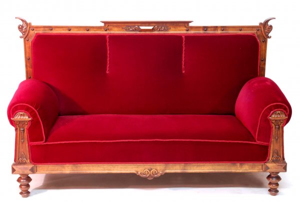 Appraisal: Victorian divan Boldy carved frame Turned feet Reupholstered in burgundy