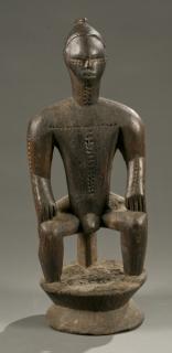 Appraisal: Bete seated male figure th century Attie staff with caryatid