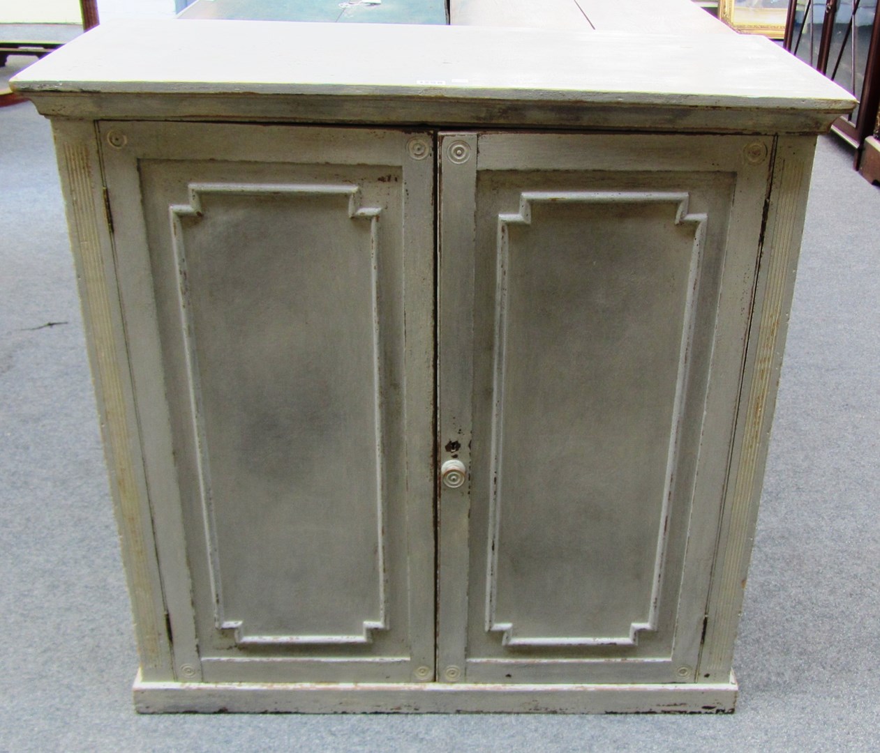 Appraisal: A grey painted two door low cupboard on plinth base