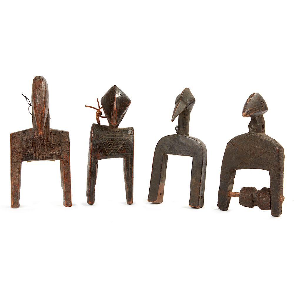 Appraisal: Four Senufo Heddle Pulleys Four Senufo wood heddle pulleys having