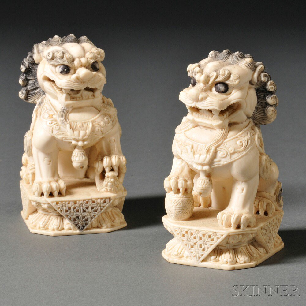 Appraisal: Pair of Ivory Carvings of Foo Lions China with incised